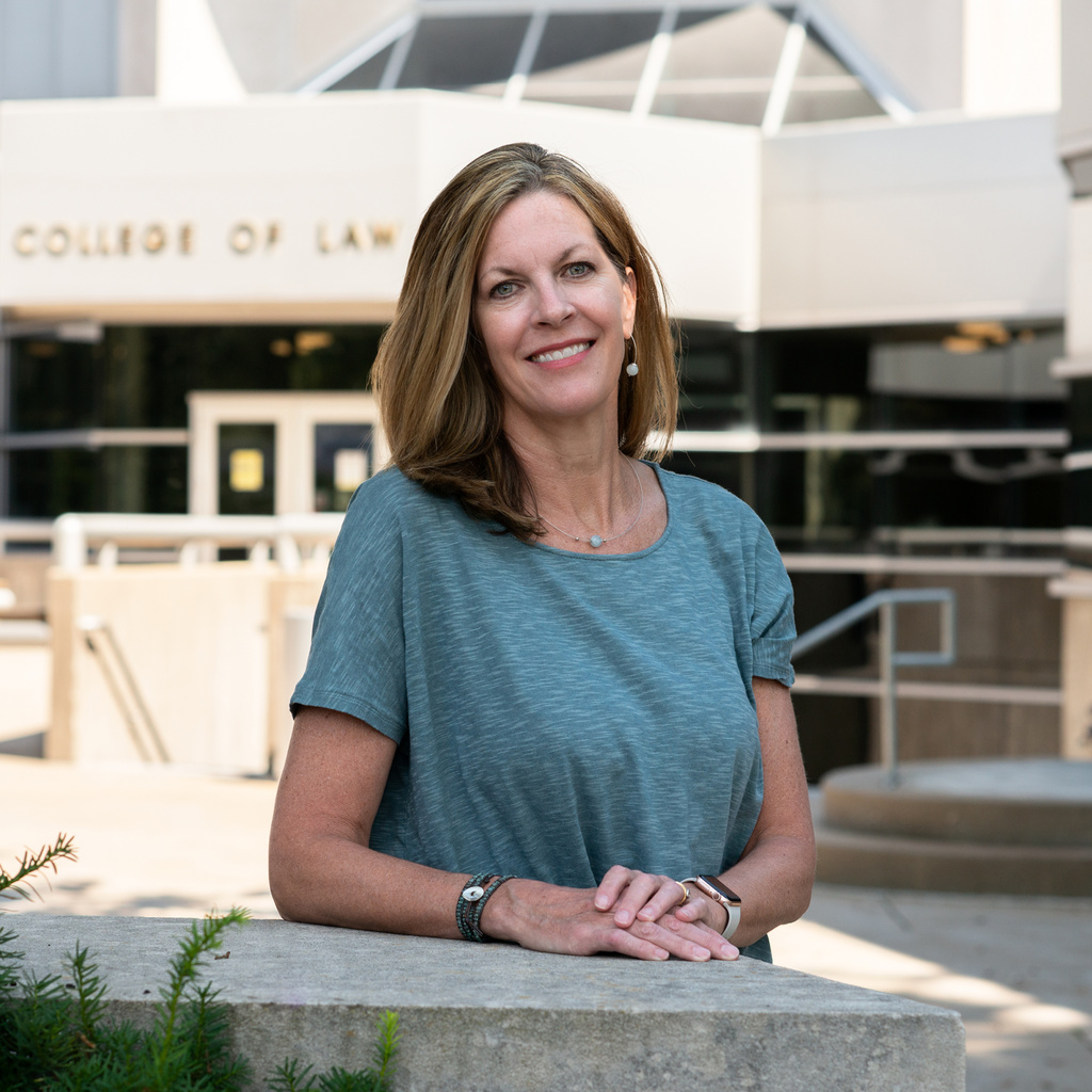 photo of Leslie Gannon in front of the College of Law building
